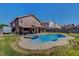 Spacious backyard with pool, spa, covered patio, and lush lawn at 3937 Country Lights St, Las Vegas, NV 89129
