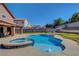 Private backyard features a pool with a spa and an outdoor dining area at 3937 Country Lights St, Las Vegas, NV 89129