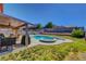 Relaxing backyard with a pool, spa, patio area, and mature trees at 3937 Country Lights St, Las Vegas, NV 89129