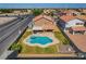 Aerial view of a backyard with a custom pool, spa, covered patio, and lush landscaping in a desirable neighborhood at 3937 Country Lights St, Las Vegas, NV 89129