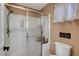 Bathroom featuring a shower with a glass door and a toilet with humorous wall art at 3937 Country Lights St, Las Vegas, NV 89129