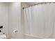 Clean bathroom featuring a shower with white curtain, tile floor and a toilet at 3937 Country Lights St, Las Vegas, NV 89129