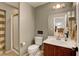 Bathroom features a shower, toilet, sink, and neutral-toned walls at 3937 Country Lights St, Las Vegas, NV 89129