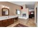 Bathroom with jacuzzi tub, double sinks, cabinets, and a fireplace at 3937 Country Lights St, Las Vegas, NV 89129