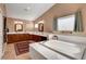 Relaxing bathroom featuring a soaking tub, double vanities, and lots of natural light at 3937 Country Lights St, Las Vegas, NV 89129