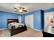 Comfortable bedroom with a large closet, ceiling fan, dresser and stylish wood-framed bed at 3937 Country Lights St, Las Vegas, NV 89129