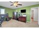 Bright bedroom with neutral carpet, ceiling fan and large dresser for storing clothes and media at 3937 Country Lights St, Las Vegas, NV 89129