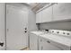 Laundry room with a washer, dryer, and storage cabinets for convenience at 3937 Country Lights St, Las Vegas, NV 89129