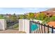 View of the crystal clear pool, relaxing sunbeds, and lush greenery from the balcony at 4 Via Vittorio Pl, Henderson, NV 89011