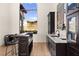 Elegant home bar features custom cabinetry, marble countertops, and views of the hills at 4 Via Vittorio Pl, Henderson, NV 89011