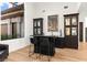 Wet bar featuring black cabinetry, light countertops, and modern fixtures at 4 Via Vittorio Pl, Henderson, NV 89011