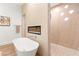 Freestanding tub with fireplace and dual head shower, accented by neutral tones at 4 Via Vittorio Pl, Henderson, NV 89011