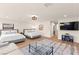 Bright and spacious bedroom featuring two beds, a seating area, and stylish decor with hardwood floors at 4 Via Vittorio Pl, Henderson, NV 89011