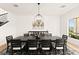 Contemporary dining room with large dark wood table and leaf-themed wall art at 4 Via Vittorio Pl, Henderson, NV 89011