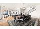 Open concept dining room with modern chandelier, staircase, and open access to kitchen at 4 Via Vittorio Pl, Henderson, NV 89011