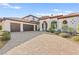 Mediterranean home with a red tile roof and three car garage and beautiful stone driveway at 4 Via Vittorio Pl, Henderson, NV 89011
