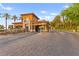 Gated community entrance featuring stone accents, lush landscaping, and a secure entry at 4 Via Vittorio Pl, Henderson, NV 89011
