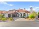 Elegant Mediterranean-style home with a red tile roof, three car garage, and lush desert landscaping at 4 Via Vittorio Pl, Henderson, NV 89011