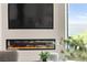 Modern fireplace with a large TV and picturesque window view at 4 Via Vittorio Pl, Henderson, NV 89011