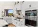 Bright kitchen featuring white cabinets, stainless steel appliances, and tile backsplash at 4 Via Vittorio Pl, Henderson, NV 89011