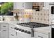 Close-up of modern kitchen with gas cooktop, tile backsplash, and quartz countertops at 4 Via Vittorio Pl, Henderson, NV 89011