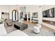 Expansive living room with a modern fireplace, an open layout, and elegant arched doors at 4 Via Vittorio Pl, Henderson, NV 89011