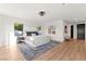 Bright, modern bedroom with light wood floors, a large window and a decorative ceiling fan at 4 Via Vittorio Pl, Henderson, NV 89011