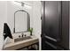 Stylish powder room featuring a decorative mirror, unique sink and sleek faucet at 4 Via Vittorio Pl, Henderson, NV 89011
