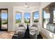 Inviting sitting area with white chairs, ottomans, and bright views at 4 Via Vittorio Pl, Henderson, NV 89011