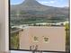 Stunning mountain views framed by the bathroom window overlooking a lake and surrounding community at 4 Via Vittorio Pl, Henderson, NV 89011