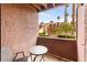 Charming balcony with outdoor seating, providing serene views of lush landscaping and community buildings at 4050 Pacific Harbors Dr # 127, Las Vegas, NV 89121