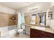 Updated bathroom featuring a bathtub/shower combination and in-unit washer and dryer at 4050 Pacific Harbors Dr # 127, Las Vegas, NV 89121