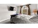 Bedroom with a window that lets in light and has a TV for viewing at 4050 Pacific Harbors Dr # 127, Las Vegas, NV 89121