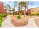 Well-maintained courtyard with mature trees and desert landscaping at 4050 Pacific Harbors Dr # 127, Las Vegas, NV 89121