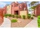 Exterior view of a multi-story condo with lush landscaping at 4050 Pacific Harbors Dr # 127, Las Vegas, NV 89121