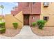 Exterior view of home entrance, with manicured landscaping and desert rock at 4050 Pacific Harbors Dr # 127, Las Vegas, NV 89121