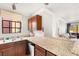 Functional kitchen featuring granite countertops, a window view, and open design for easy entertaining at 4050 Pacific Harbors Dr # 127, Las Vegas, NV 89121