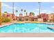 Community pool surrounded by lounge chairs and landscaping, perfect for relaxation at 4050 Pacific Harbors Dr # 127, Las Vegas, NV 89121