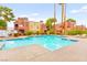 Sparkling community pool with lounge chairs and lush desert landscaping at 4050 Pacific Harbors Dr # 127, Las Vegas, NV 89121