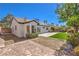 Expansive backyard showcasing a manicured lawn, mature trees, and a paved patio area for relaxation at 410 Aloha Dr, Henderson, NV 89015