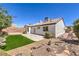 Inviting backyard with artificial turf, low-maintenance landscaping, and a charming patio area at 410 Aloha Dr, Henderson, NV 89015