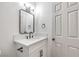 Elegant bathroom features a white vanity, modern fixtures, and a sleek, dark-framed mirror at 410 Aloha Dr, Henderson, NV 89015