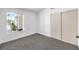 Bedroom featuring neutral walls and carpet, with natural light from the window and large closet at 410 Aloha Dr, Henderson, NV 89015