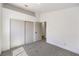 Bedroom featuring neutral walls and carpet, and a peek into an adjacent bathroom at 410 Aloha Dr, Henderson, NV 89015