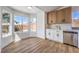 Kitchen nook featuring stainless dishwasher, wood and white cabinets, and a view of the backyard at 410 Aloha Dr, Henderson, NV 89015