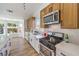 Bright kitchen featuring stainless appliances, sleek countertops, and updated cabinets at 410 Aloha Dr, Henderson, NV 89015