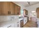 Well-lit kitchen with stainless appliances, sleek countertops, tile backsplash, and updated cabinets at 410 Aloha Dr, Henderson, NV 89015