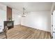 Open-concept living room with wood-look floors, fireplace, fresh white paint, and view to the backyard at 410 Aloha Dr, Henderson, NV 89015