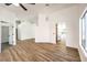 Open-concept living room with wood-look floors, fresh white paint, and an open view to the kitchen at 410 Aloha Dr, Henderson, NV 89015