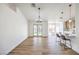 Open-concept living room with wood-look floors, fireplace, fresh white paint, and view to the backyard at 410 Aloha Dr, Henderson, NV 89015
